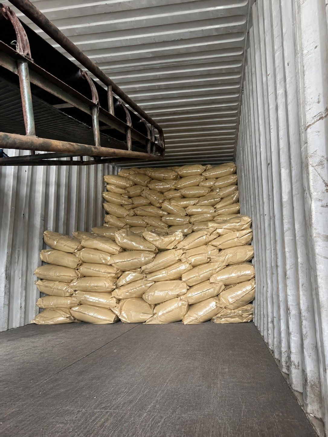 20kg kraft bags stacked inside a sea container being loaded